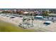 Aerial view of a waterfront community featuring a beach, parking, and seating areas at 4921 Marlin Dr, New Port Richey, FL 34652