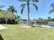 Lawn and dock with palm trees offer relaxing outdoor living at 4921 Marlin Dr, New Port Richey, FL 34652