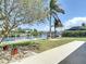 Waterfront backyard featuring lawn, landscaping, walkway, and access to dock at 4921 Marlin Dr, New Port Richey, FL 34652