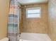 Bathtub with tiled wall and showerhead at 4921 Marlin Dr, New Port Richey, FL 34652
