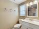 The bathroom is equipped with a shower, toilet, sink, vanity, mirror, and window at 4921 Marlin Dr, New Port Richey, FL 34652