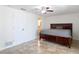 This spacious bedroom features a ceiling fan, tile floor, and neutral paint color at 4921 Marlin Dr, New Port Richey, FL 34652