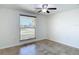 Bedroom with a ceiling fan and a large window with blinds at 4921 Marlin Dr, New Port Richey, FL 34652