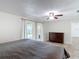 This bedroom features a sliding glass door, dresser, and ceiling fan at 4921 Marlin Dr, New Port Richey, FL 34652