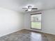 Bedroom featuring ceramic tile floors, a ceiling fan, and a window offering natural light at 4921 Marlin Dr, New Port Richey, FL 34652