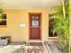 Close-up of the front door with a security screen and decorative tile walkway at 4921 Marlin Dr, New Port Richey, FL 34652