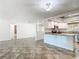 Modern kitchen with granite countertops, white cabinetry, and stainless steel appliances at 4921 Marlin Dr, New Port Richey, FL 34652