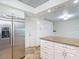 Kitchen boasts granite countertops, stainless steel refrigerator, and ample white cabinet space for storage at 4921 Marlin Dr, New Port Richey, FL 34652
