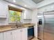 Bright kitchen with stainless steel appliances and granite countertops providing a clean and functional workspace at 4921 Marlin Dr, New Port Richey, FL 34652