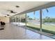 Screened lanai featuring tile flooring, ceiling fans, and views of the waterfront at 4921 Marlin Dr, New Port Richey, FL 34652