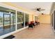Open lanai with tile flooring, ceiling fans, and comfortable outdoor seating at 4921 Marlin Dr, New Port Richey, FL 34652