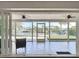 A covered patio offers a view of the canal, seating area, and sliding glass doors at 4921 Marlin Dr, New Port Richey, FL 34652