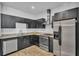 Modern kitchen featuring dark cabinets, stainless steel appliances, and stylish backsplash at 5008 S Macdill Ave # 12, Tampa, FL 33611