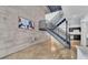 Modern living area with concrete wall, open staircase, and view of the kitchen at 5008 S Macdill Ave # 12, Tampa, FL 33611