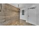 Minimalist living room featuring a neutral palette, exposed brick wall, modern lighting fixture, and polished concrete floors at 5008 S Macdill Ave # 12, Tampa, FL 33611
