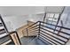 Modern staircase with metal railings leading to bright open living space and balcony at 5008 S Macdill Ave # 12, Tampa, FL 33611