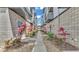 Walkway with a stone path, flanked by manicured pink and green plants, leads to the entrance at 5008 S Macdill Ave # 12, Tampa, FL 33611