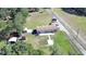 Wide aerial shot showing the expansive property with lush vegetation, a home, and multiple outbuildings at 8318 Franklin Rd, Plant City, FL 33565