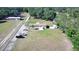 Expansive lot featuring a charming single-story home, shed, and ample parking surrounded by lush greenery and a private driveway at 8318 Franklin Rd, Plant City, FL 33565