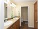 Bathroom featuring double sinks, wood cabinets, and a separate toilet room at 8318 Franklin Rd, Plant City, FL 33565