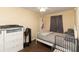 Small bedroom with gray walls, bed, dresser, and an overhead ceiling fan at 8318 Franklin Rd, Plant City, FL 33565