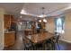 Open dining area with a large wooden table, seating for six, and wood-look flooring at 8318 Franklin Rd, Plant City, FL 33565