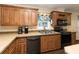 Well-lit kitchen featuring wooden cabinets, modern appliances, and a functional layout at 8318 Franklin Rd, Plant City, FL 33565