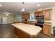 Well-equipped kitchen with island, stainless steel appliances, and a breakfast bar for casual dining at 8318 Franklin Rd, Plant City, FL 33565