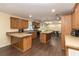 Bright kitchen with wood cabinets, an island, and an open view to the dining area at 8318 Franklin Rd, Plant City, FL 33565