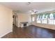 Bright and airy living room with modern flooring, large windows, and a stylish media console at 8318 Franklin Rd, Plant City, FL 33565