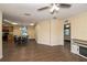 Open concept living area with hardwood floors, ceiling fan, fireplace, and ample natural light with an open view of the kitchen at 8318 Franklin Rd, Plant City, FL 33565