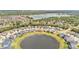 Aerial view showcases a home nestled within a community featuring ponds and lush landscaping at 9015 Spruce Creek Cir, Riverview, FL 33578