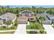 An aerial view of a two-story house with solar panels, landscaped yard, and driveway at 9015 Spruce Creek Cir, Riverview, FL 33578