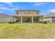 Expansive backyard featuring a covered patio, perfect for outdoor living and entertaining at 9015 Spruce Creek Cir, Riverview, FL 33578