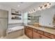 Spa-like bathroom with a soaking tub, dual sinks, and modern fixtures at 9015 Spruce Creek Cir, Riverview, FL 33578