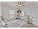 Bright bedroom featuring a decorative dresser, ceiling fan, and ample natural light at 9015 Spruce Creek Cir, Riverview, FL 33578