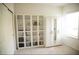 Bright bedroom features a built-in wardrobe and shelving for ample storage solutions at 9015 Spruce Creek Cir, Riverview, FL 33578