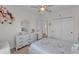 Cozy bedroom featuring a decorative dresser, ceiling fan, and ample natural light at 9015 Spruce Creek Cir, Riverview, FL 33578