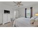 Bedroom with neutral walls, carpet and ceiling fan has access to a balcony at 9015 Spruce Creek Cir, Riverview, FL 33578
