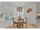 Sunlit breakfast nook with a round table, seating for four, and a modern chandelier at 9015 Spruce Creek Cir, Riverview, FL 33578