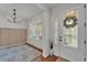 Bright entryway featuring hardwood floors, a decorative front door, and neutral wall colors at 9015 Spruce Creek Cir, Riverview, FL 33578