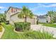Charming home featuring a two-car garage, well-manicured lawn, and lush landscaping at 9015 Spruce Creek Cir, Riverview, FL 33578