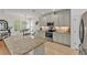 Spacious kitchen featuring granite countertops and a dining area with natural light at 9015 Spruce Creek Cir, Riverview, FL 33578