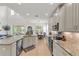 Well-lit kitchen with granite countertops, an island, and dining area view at 9015 Spruce Creek Cir, Riverview, FL 33578