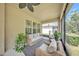 Inviting screened lanai with comfortable seating and a view of the backyard at 9015 Spruce Creek Cir, Riverview, FL 33578