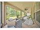 Spacious screened lanai with comfortable seating, ceiling fan, and backyard view at 9015 Spruce Creek Cir, Riverview, FL 33578