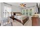 Spacious main bedroom suite with large windows, ceiling fan, and bedside tables at 9015 Spruce Creek Cir, Riverview, FL 33578