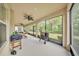 Spacious screened patio with ceiling fan and outdoor grill, ideal for entertaining at 9015 Spruce Creek Cir, Riverview, FL 33578