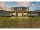 View of the home's rear exterior showing the large screened lanai at 9015 Spruce Creek Cir, Riverview, FL 33578