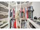 Custom walk-in closet with rods, shelves and storage solutions at 9015 Spruce Creek Cir, Riverview, FL 33578